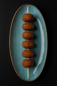 a blue plate with four oatmeal cookies on it at فندق روزالينا in Yanbu