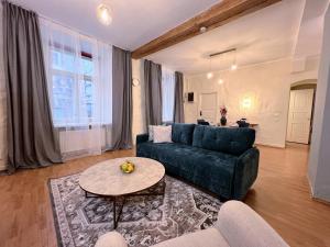 a living room with a couch and a table at Reval Residences Old Town in Tallinn