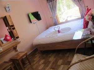 En eller flere senge i et værelse på Sapa Backpacker Hostel