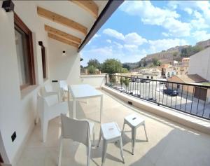a balcony with a table and chairs and a view at The White House Toledo in Toledo