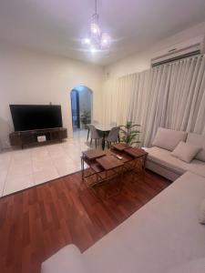 a living room with a couch and a table at Lulu Luxury Apartment 1 one Bedroom in Al Khobar