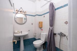 a bathroom with a toilet and a sink at Cyclades Beach Apartments in Platis Gialos +47 photos