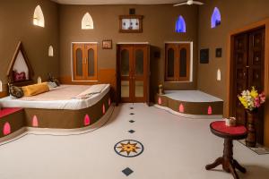 a bedroom with two beds and a tub in it at VVIP Gajban Resort & Desert Stay, Bikaner in Bikaner +141 photos