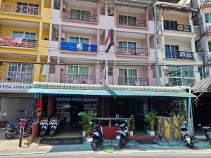 a group of motorcycles parked in front of a building at Bursa Hotel Patong in Patong Beach