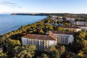 an aerial view of a building next to the water at IFA Rügen Hotel & Ferienpark in Binz