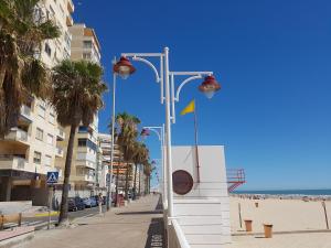 a street lights on a beach with a yellow flag at Brisas Cayetano in Cádiz