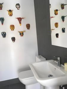 a bathroom with a white toilet and a sink at Villa Rompido in El Rompido