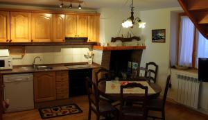 a kitchen with a table and a dining room at Casa Es De Bernat 2 in Garós