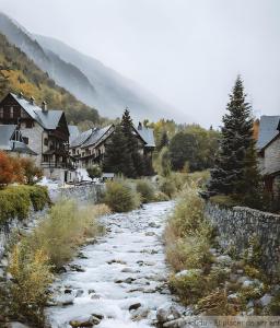 a snow covered road in a village with houses at Casa Es De Bernat 2 in Garós