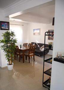 a living room with a table and chairs and a couch at Bellomar I Exclusive Juan Dolio Playa Hemingway in Juan Dolio