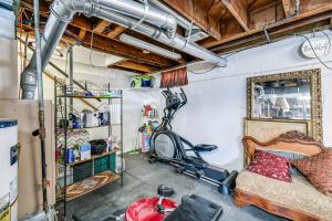 un garage avec une pièce contenant un lit et un tapis roulant dans l'établissement Art Lovers Paradise! Cozy Cottage in Huntington, à Huntington