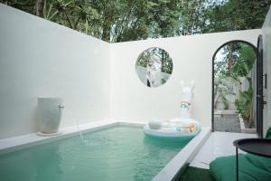 a swimming pool with a water feature in a house at Lasakha Villa in Bantul