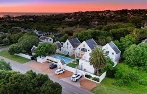 an aerial view of a house with a palm tree at Adrift Guesthouse in St Francis Bay