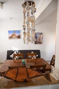 a dining room with a table and a chandelier at Bellomar I Exclusive Juan Dolio Playa Hemingway in Juan Dolio
