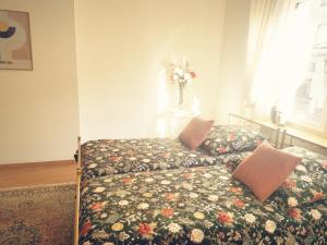 a bedroom with a bed and a vase of flowers at Chez Ninon in Freyming
