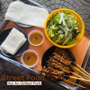 a tray of food with meat and a salad and sauce at HY Local Budget Hotel - 5 mins walk to Hoi An Ancient Town in Hoi An