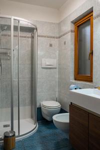 a bathroom with a shower and a toilet and a sink at MH-Luxury Apartments in Cavalese +46 photos