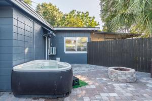 a jacuzzi tub sitting outside of a house at CUTE and COZY studio w jacuzzi in Orlando