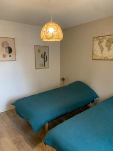 Ένα ή περισσότερα κρεβάτια σε δωμάτιο στο La petite porteloise