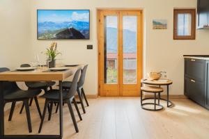 a kitchen and dining room with a table and chairs at MH Luxury Apartments in Cavalese