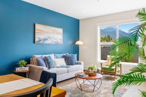 a living room with a couch and a table at Stylish 2BR Golden Getaway with BBQ and Stunning Views in Golden