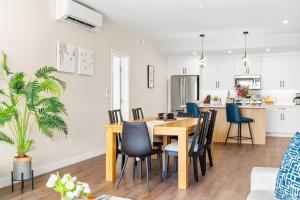 a dining room and kitchen with a table and chairs at Stylish 2BR Golden Getaway with BBQ and Stunning Views in Golden