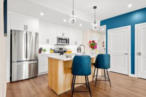 a kitchen with white cabinets and blue accents at Stylish 2BR Golden Getaway with BBQ and Stunning Views in Golden +18 photos