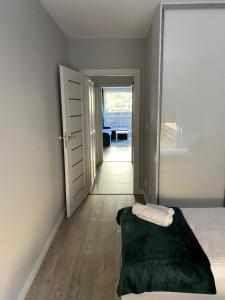 a bedroom with a bed and a door leading to a hallway at Apartament da Vinci in Wrocław