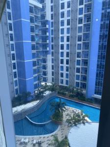 a view of the pool from the balcony of a building at Elegant Studio in Mivela Garden Residences in Banilad