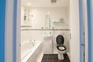 une salle de bain avec toilettes, baignoire et lavabo dans l'établissement Central Renfrew 1BR Apt, à Renfrew