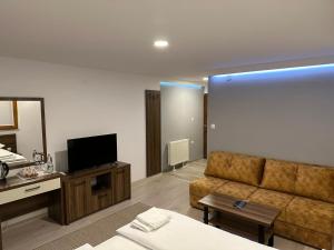 a living room with a couch and a television at Villa Merdan in Vlasic
