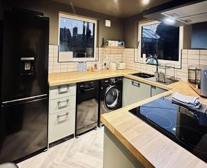 a kitchen with a washer and dryer in it at Modern 3BR Smart Home in Peterhead