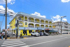a yellow building with cars parked in front of it at SURFRIDER Dewey Beach Ocean Block in Dewey Beach