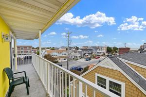 a balcony with a chair and a view of a street at SURFRIDER Dewey Beach Ocean Block in Dewey Beach