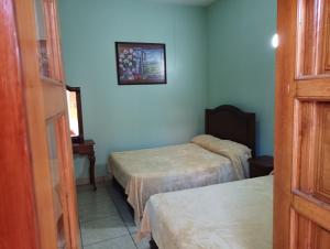 Postel nebo postele na pokoji v ubytování Hotel Real de Cortés