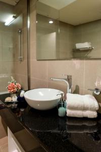a bathroom with a white sink on a counter at Beachfront Home with Sea View - 2BR, 134m2 in Lusail