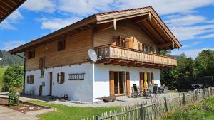 a small house with a balcony and a deck at Chalet Steinplatte in Reit im Winkl