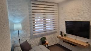 a living room with a large flat screen tv at Lo Pateret in Corbera