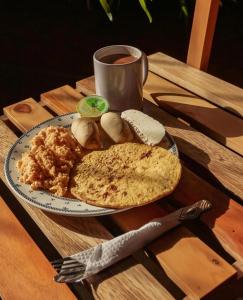 a plate of food with bread and a cup of coffee at Apartamento turístico jardín Antioquia in Jardin
