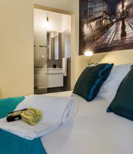 a bedroom with a bed with a towel on it at Alfar Aqueduct - Évora House in Évora