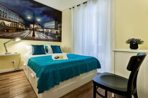 a bedroom with a bed with a blue comforter at Alfar Aqueduct - Évora House in Évora +4 photos