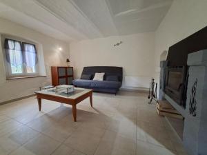 a living room with a couch and a coffee table at Gîte de Fond Carle in Miribel-Lanchâtre