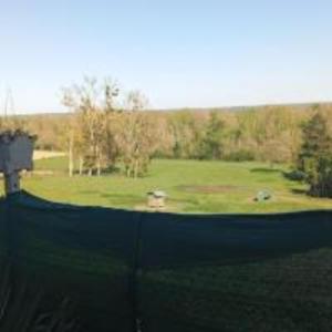 a man is standing on a golf green at La Canardière house in Châtel-de-Neuvre