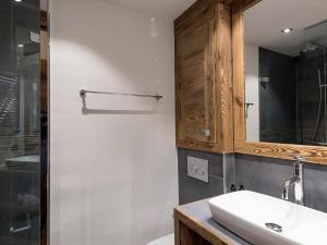 a bathroom with a sink and a mirror at Appartement de standing à Courchevel avec vue, proche des pistes, parking inclus - FR-1-575-59 in Courchevel +5 photos
