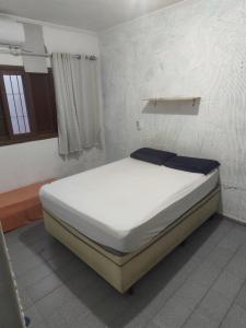 a bedroom with a bed in a room at Casa Tupy próxima a praia e restaurantes in Praia Grande