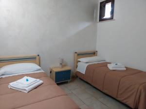 two beds sitting next to each other in a room at Desiree Casa Vacanze in Avola