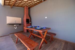 a room with a table and a bench and a screen at Zen Spa Houses in São Miguel dos Milagres +27 photos