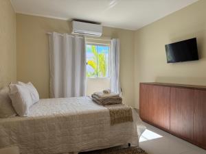 TV a/nebo společenská místnost v ubytování Pousada Hari - ar condicionado e piscina