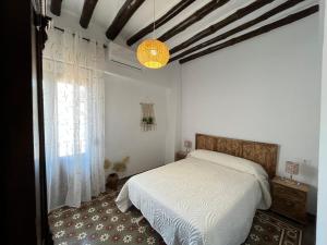 ein Schlafzimmer mit einem weißen Bett und einem Fenster in der Unterkunft Alojamientos El Carmen in Ugíjar + 29 Fotos