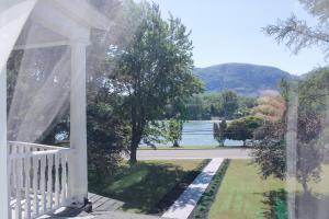 a view of the water from the porch of a house at Gite La Cache in Beloeil Village